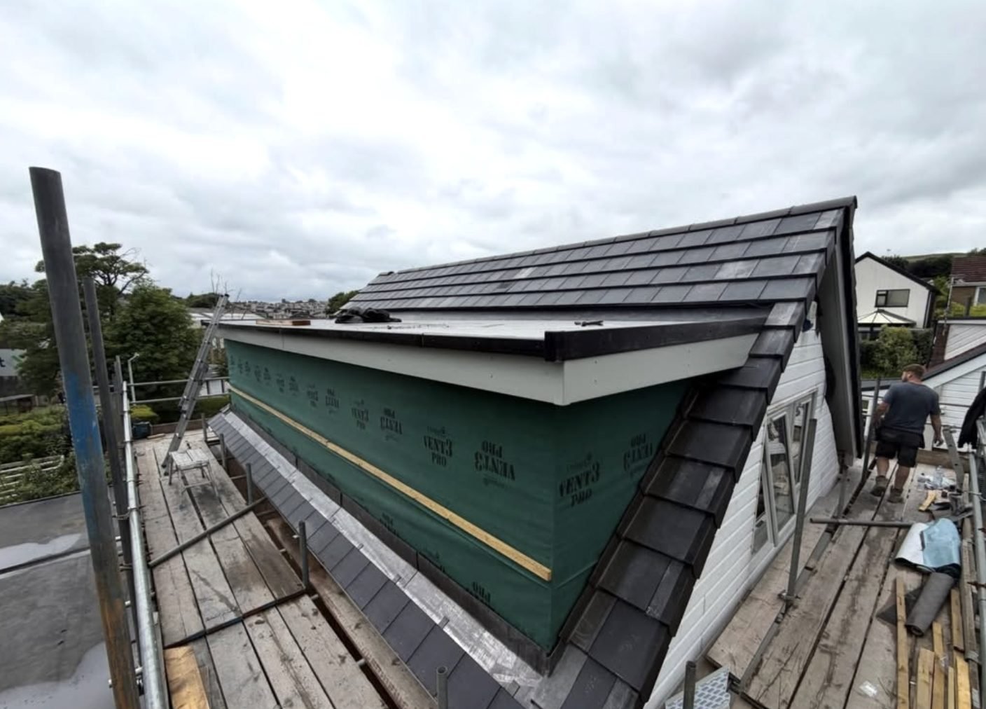Dormer roof being tiled from scaffold, breathable membrane on the dormer face