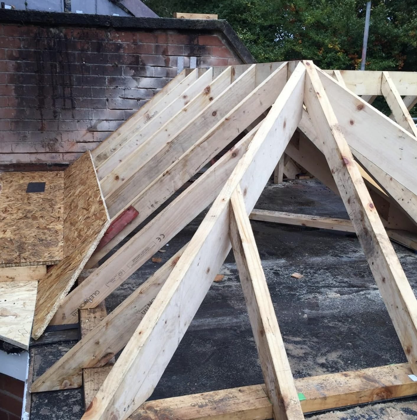 New timber hip roof framed out over an old flat roof