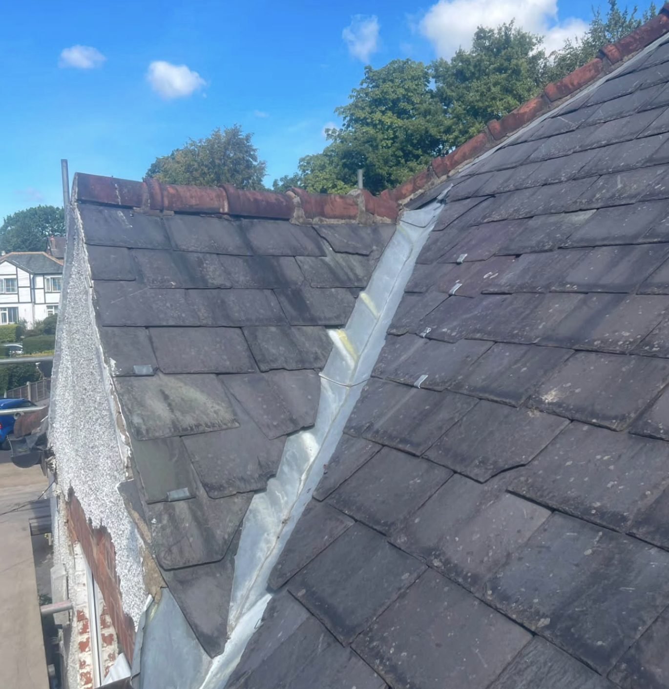 Lead valley running between two older slate roof slopes